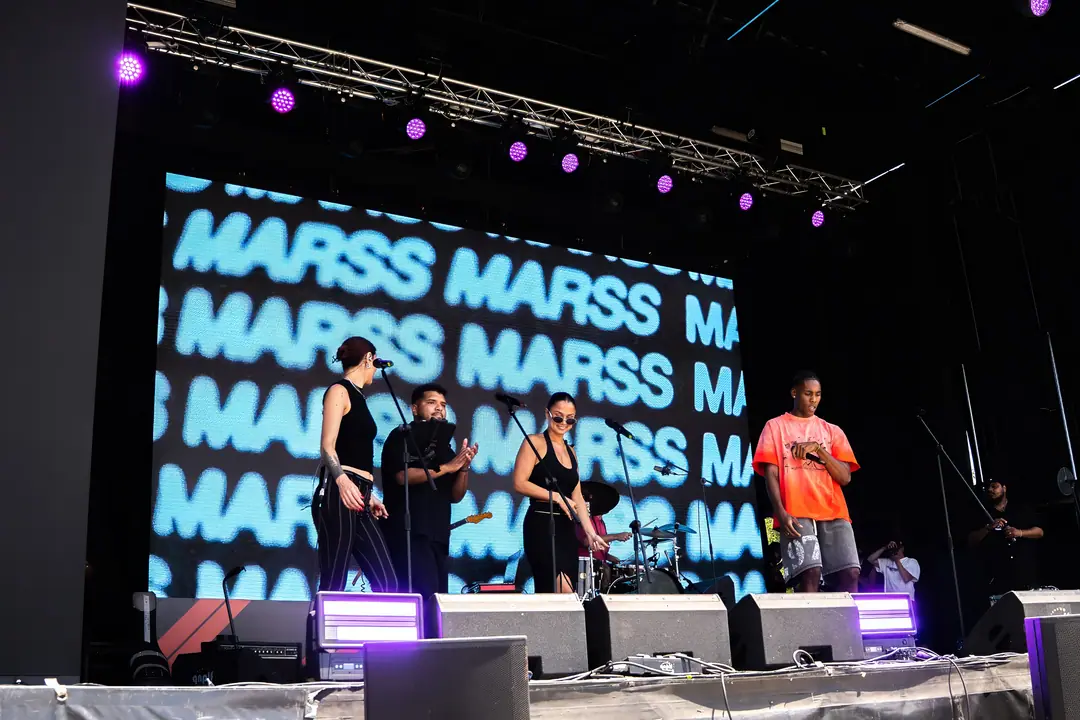 A live set on the Fan Zone main stage, singers and band in front of the LED wall